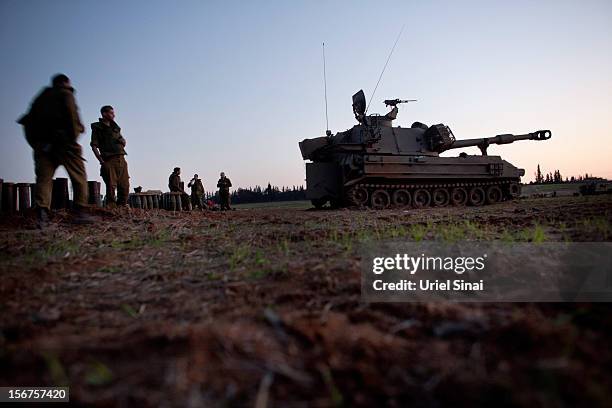 Israeli soldiers stand next to artillery guns as the conflict between Palestine and Gaza enters its seventh day on November 20, 2012 on Israel's...