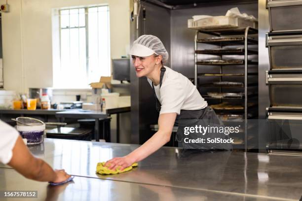 getting the surface clean for tomorrow - cleaning metal table stock pictures, royalty-free photos & images