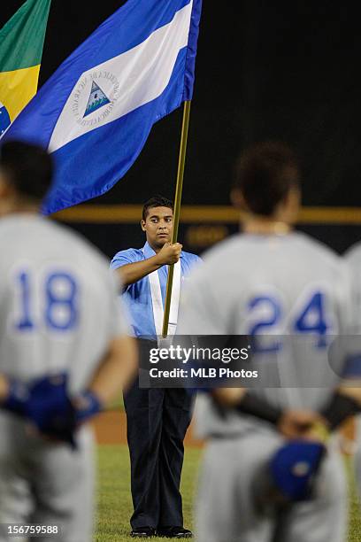 Volunteer is seen holding the Nicaraguan flag during the pre-game ceremony before Game 4 of the Qualifying Round of the World Baseball Classic...