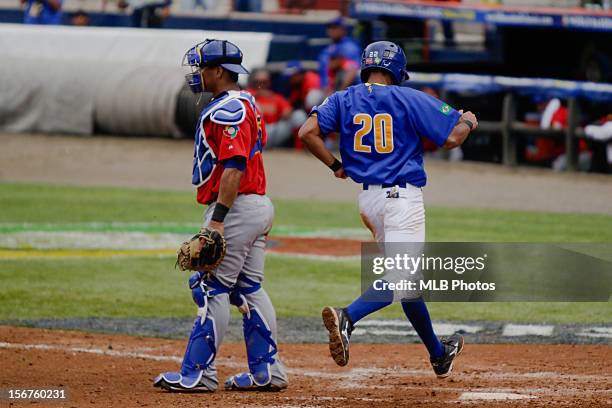 Leonardo Reginatto of Team Brazil scores a run in the bottom of the fifth inning during Game 3 of the Qualifying Round of the World Baseball Classic...