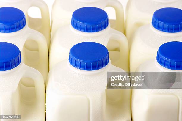 pint milk containers arranged in rows - milk jug stock pictures, royalty-free photos & images