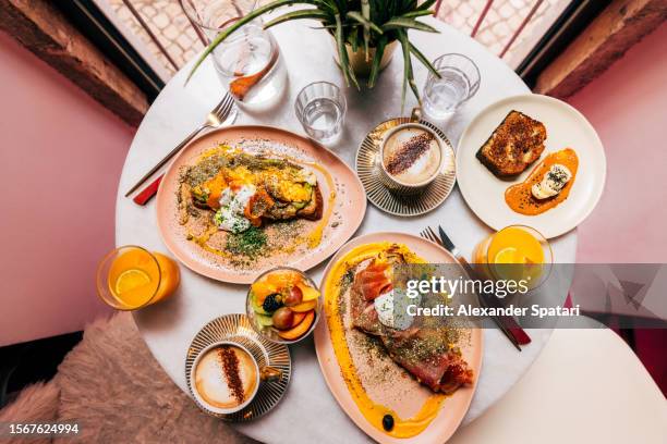 healthy colourful breakfast for two served in a cafe, high angle view - food styling restaurant stock pictures, royalty-free photos & images
