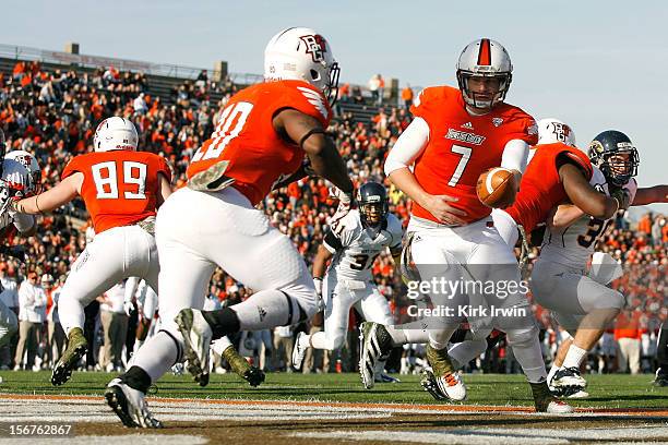 Matt Schilz of the Bowling Green Falcons hands the ball off to John Pettigrew of the Bowling Green Falcons during the game against the Kent State...