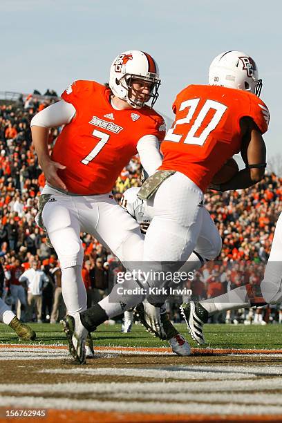 Matt Schilz of the Bowling Green Falcons hands the ball off to John Pettigrew of the Bowling Green Falcons during the game against the Kent State...