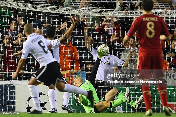 Sofiane Feghouli of Valencia scores the opening goal against Manuel Neuer, keeper of Muenchen during the UEFA Champions League group F match between...
