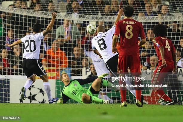 Sofiane Feghouli of Valencia scores the opening goal against Manuel Neuer, keeper of Muenchen during the UEFA Champions League group F match between...