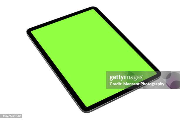 digital tablet mockup with chroma key green screen isolated lying in three quarters on white background - graphics tablet stock pictures, royalty-free photos & images