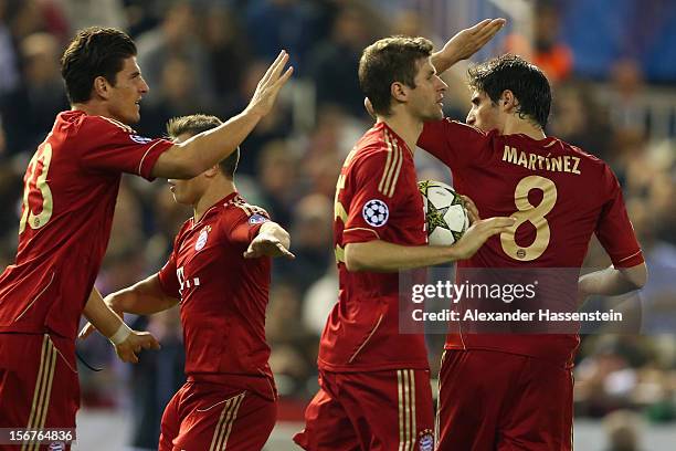 Thomas Mueller of Bayern Muenchen celebrates scoring his first team goal with his team mates during the UEFA Champions League group F match between...