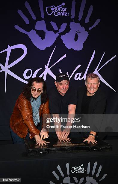 Rush Geddy Lee, Neil Peart, Alex Lifeson, Honored On Guitar Center's RockWalk at Guitar Center on November 20, 2012 in Hollywood, California.