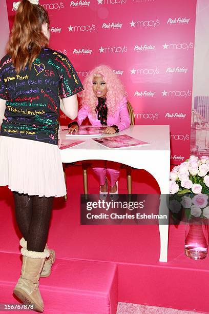 Singer Nicki Minaj autographs posters at "Pink Friday" Fragrance Holiday Season Celebration at Macy's Queens Center on November 20, 2012 in the...