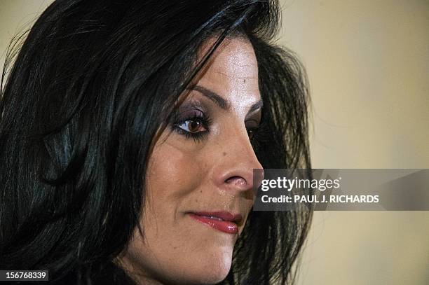 Natalie Khawam listens as her attornedy Gloria Allred conducts a press conference on November 20 at the Ritz-Carlton hotel in Washington. Khawam is...