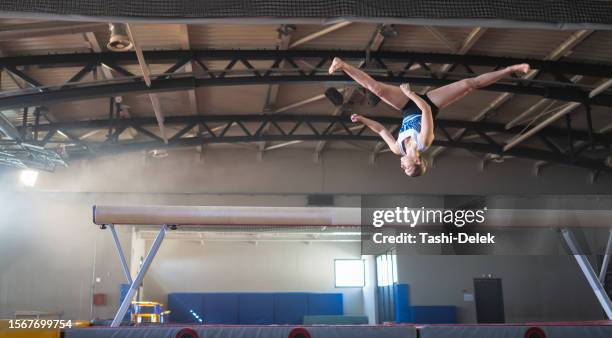 female gymnast on balance beam - professional sportsperson stock pictures, royalty-free photos & images