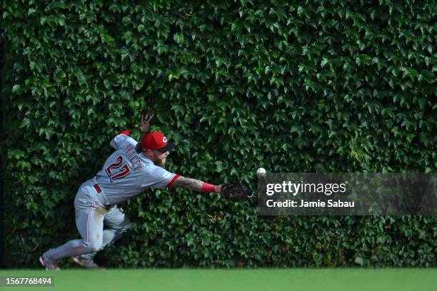 Jake Fraley of the Cincinnati Reds drops a ball hit by Cody Bellinger of the Chicago Cubs for a double in the third inning at Wrigley Field on July...