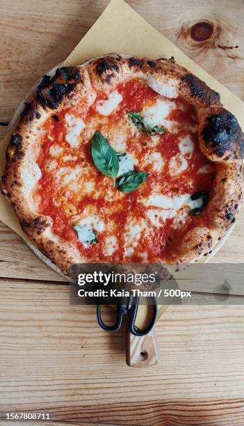 directly above shot of pizza on table - cheese pizza stock pictures, royalty-free photos & images