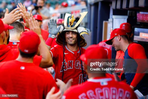 Randal Grichuk of the Los Angeles Angels celebrates in the dugout after hitting a home run during the fourth inning against the Atlanta Braves at...