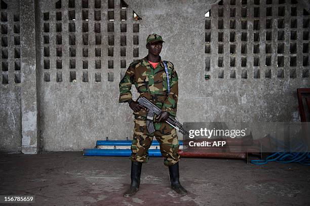 An M23 rebel stands in the Volcanoes Stadium in the restive eastern city of the Democratic Republic of the Congo on November 21, 2012. M23 rebels...