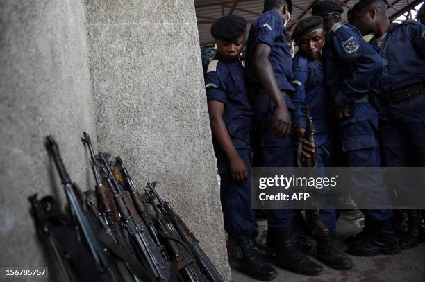 Surrendered police officers hand-in their weapons at the Volcanoes Stadium in Goma, in the east of the Democratic Republic of the Congo, on November...