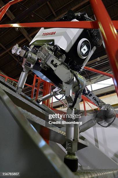 Toshiba Corp. Tetrapod robot walks down stairs at the company's Yokohama Complex in Yokohama City, Kanagawa Prefecture, Japan, on Wednesday, Nov. 21,...