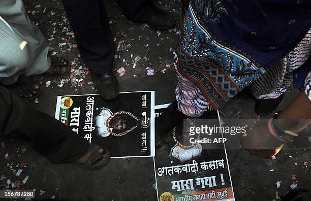 India's Bharatiya Janta Party activists step on posters of Pakistan-born Mohammed Kasab, the sole surviving gunman of the 2008 Mumbai attacks, as...