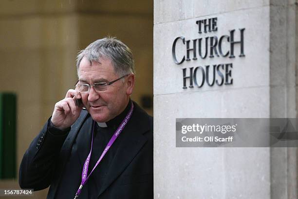 The Reverend Canon Glyn Webster speaks on his phone outside Church House on the final day of the General Synod on November 21, 2012 in London,...