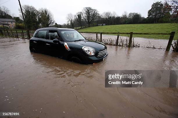 Car sits stuck in flood water on a lane in the village of Chilcompton on November 21, 2012 near Wells, England. Heavy rain overnight has brought...