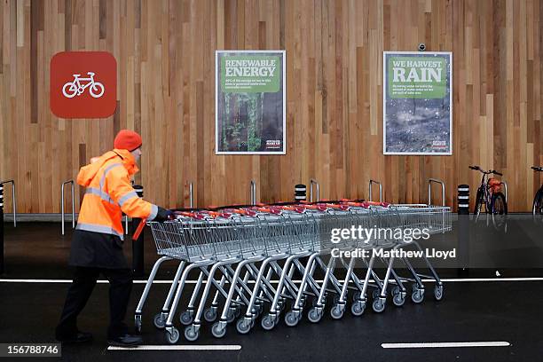 Colleague moves trolleys in the car park of Sainsbury's new Kings Lynn supermarket, one of the retailer's most energy efficient stores on 21 November...