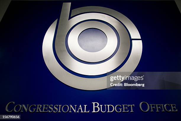 Sign for the Congressional Budget Office hangs in a hallway in Washington, D.C., U.S., on Tuesday, Nov. 13, 2012. President Barack Obama expressed...