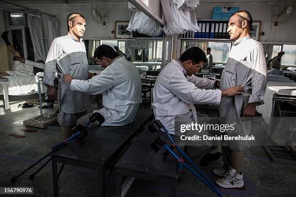 An orthopedic specialist fits a new prosthetic limb onto a patient at the International Committee of the Red Cross , orthopedic centre on November...