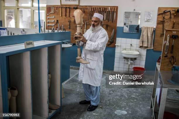 An orthopedic technician observes the mechanics of a prosthetic limb at the International Committee of the Red Cross , orthopedic centre on November...