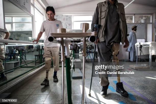 Jawad an Afghan National Police officer who lost his leg after stepping on an IED while on patrol a year ago, practices walking on his prosthetic leg...