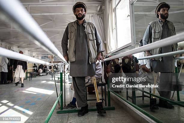 Habibullah a tailor from Wardak province, lost his leg when he drove over an IED a year ago, practices walking on his new artificial limb on his...