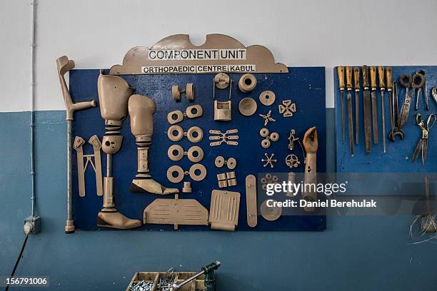 Orthopedic components hang on a wall in a workshop at the International Committee of the Red Cross , orthopedic centre on November 19, 2012 in Kabul,...