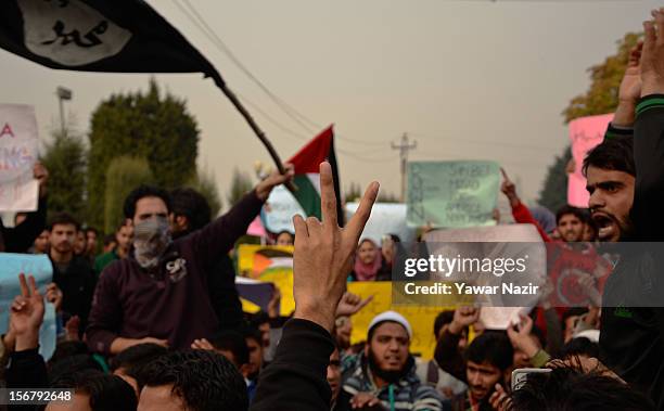 Kashmiri Muslim students of Kashmir University hold placards and banners as they shout anti-Israeli slogans during a protest against Israel and in...