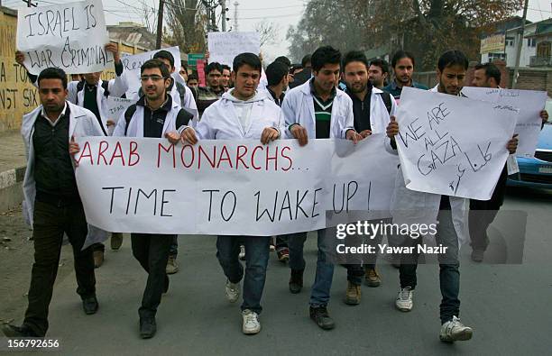 Kashmiri doctors march on a street as they hold banners and placards during a protest against Israel and in solidarity with Gaza at SMHS medical...