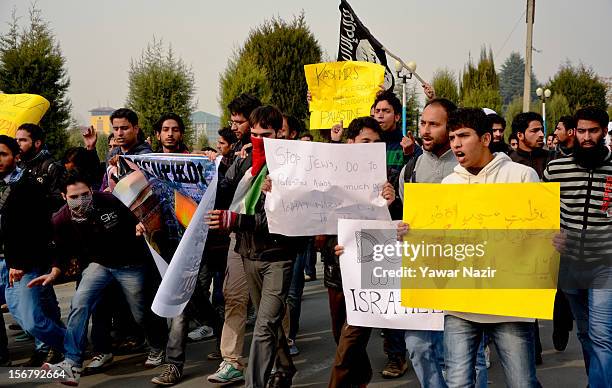 Kashmiri Muslim students of Kashmir University hold placards and banners as they shout anti-Israeli slogans during a protest against Israel and in...