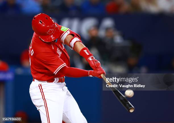 Whit Merrifield of the Toronto Blue Jays hits a home run in the eighth inning against the Baltimore Orioles at Rogers Centre on July 31, 2023 in...