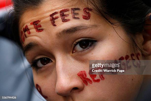 Protester demonstrating against education cuts, tuition increases and austerity has a slogan painted on her face on November 21, 2012 in London,...