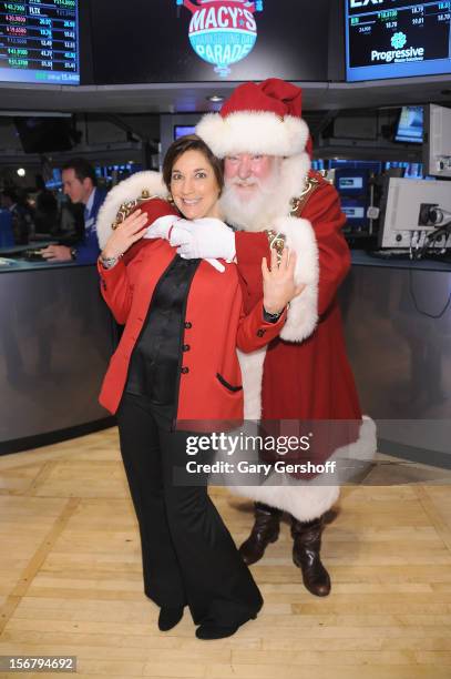 Executive Producer of Macy's Thanksgiving Day Parade, Amy Kule and Santa Claus pose for pictures after ringing the opening bell at the New York Stock...