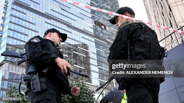 Police officers block off an area around a damaged office block of the Moscow International Business Center following a reported drone attack in...
