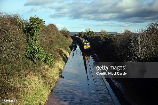Train waits to pass along flooded track close to the village of North Curry on November 21, 2012 near Taunton, England. Heavy rain overnight has...