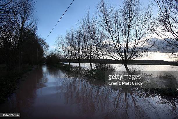 The sun reflects on the water in flooded fields and roads close to the village of North Curry on November 21, 2012 near Taunton, England. Heavy rain...