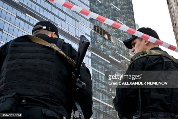 Police officers block off an area around a damaged office block of the Moscow International Business Center following a reported drone attack in...