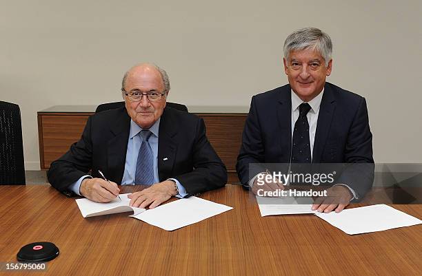 In this handout image provided by The FA, FIFA President Joseph S Blatter and FA chairman David Bernstein jointly sign a Memorandum of Understanding...