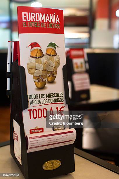 Promotional cards advertising one euro menus as part of "Euromania" Wednesdays stand on tables in a 100 Montaditos restaurant in Madrid, Spain, on...