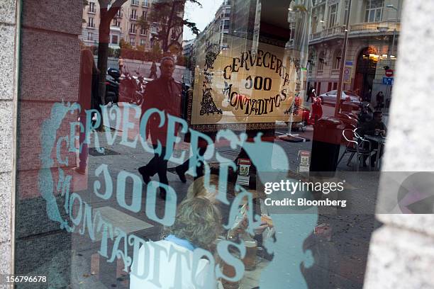 Logos are seen through the window of a 100 Montaditos restaurant in Madrid, Spain, on Wednesday, Nov. 21, 2012. The Madrid-based chain in January...