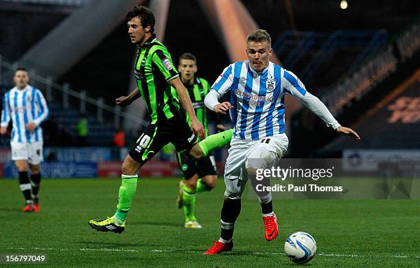 Danny Ward of Huddersfield Town takes the ball past Will Buckley of Brighton during the npower Championship match between Huddersfield Town and...