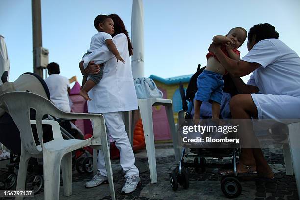 Maids hold childred at the Baixo Bebe beach playground in Rio de Janeiro, Brazil, on Monday, Nov. 19, 2012. With unemployment in Latin America’s...