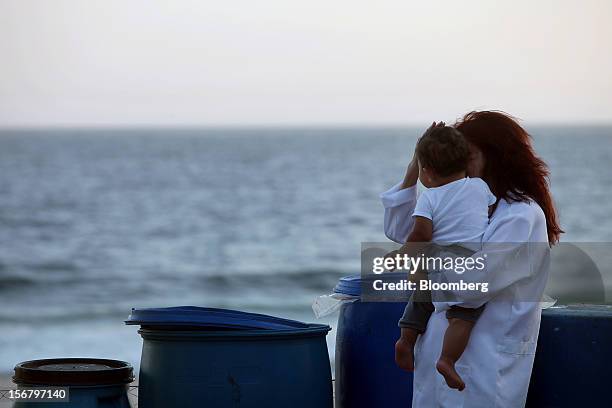 Maid holds a child at the Baixo Bebe beach playground in Rio de Janeiro, Brazil, on Monday, Nov. 19, 2012. With unemployment in Latin America’s...