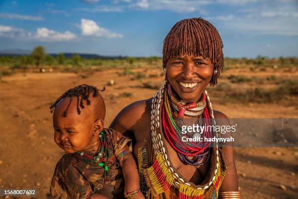 woman from hamer tribe holding her baby, ethiopia, africa - hamar stock pictures, royalty-free photos & images