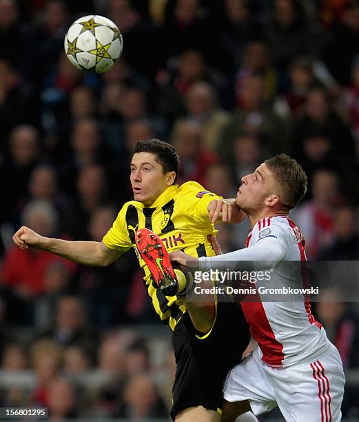 Robert Lewandowski of Dortmund and Toby Alderweireld of Amsterdam go up for a header during the UEFA Champions League Group D match between Ajax...